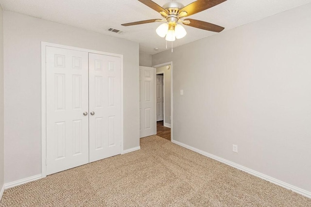 2502 Lake Valley Dr, Garland, TX 75040 - unfurnished bedroom with carpet, a closet, baseboards, and a ceiling fan