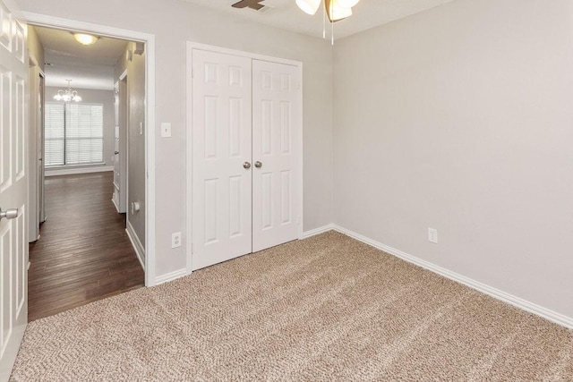 2502 Lake Valley Dr, Garland, TX 75040 - unfurnished bedroom featuring a chandelier, carpet floors, a closet, and baseboards