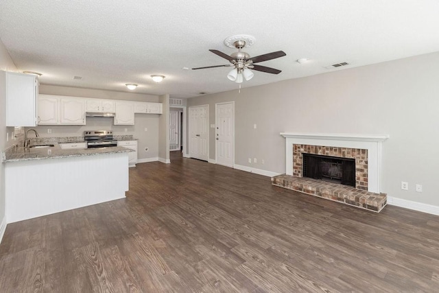 2502 Lake Valley Dr, Garland, TX 75040 - unfurnished living room with ceiling fan, a sink, baseboards, and dark wood-style flooring