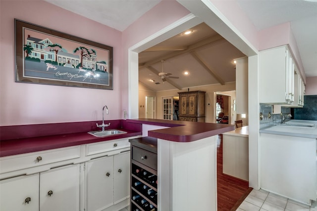 6921 Vineridge Dr, Dallas, TX 75248 - kitchen with a sink, a peninsula, white cabinetry, and ceiling fan