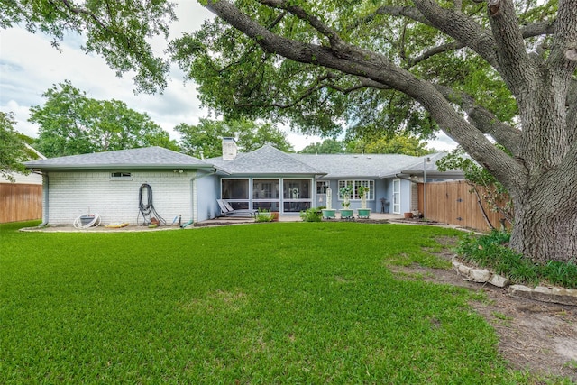 6921 Vineridge Dr, Dallas, TX 75248 - back of house featuring a sunroom, a chimney, brick siding, a shingled roof, and a gate