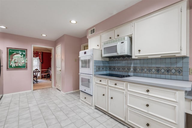 6921 Vineridge Dr, Dallas, TX 75248 - kitchen featuring white appliances, light countertops, tasteful backsplash, white cabinetry, and recessed lighting