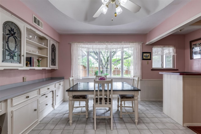 6921 Vineridge Dr, Dallas, TX 75248 - dining room featuring wainscoting, a ceiling fan, and light tile patterned flooring