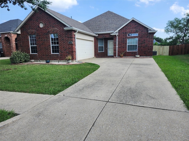 4026 Carrington Dr, Garland, TX 75043 - traditional home with brick siding, driveway, an attached garage, roof with shingles, and central air condition unit