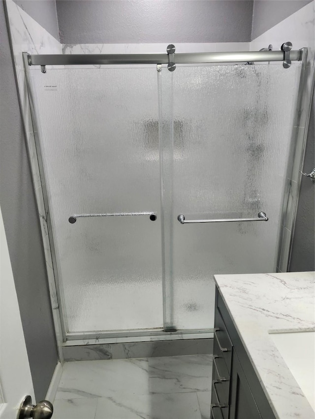 4026 Carrington Dr, Garland, TX 75043 - bathroom featuring marble finish floors, vanity, and a shower stall