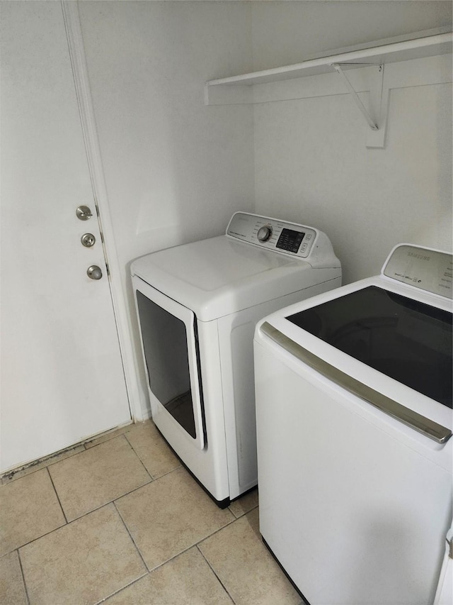 4026 Carrington Dr, Garland, TX 75043 - washroom with separate washer and dryer and light tile patterned floors