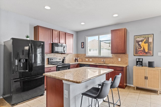 9129 Blackstone Dr, Providence Village, TX 76227 - kitchen with black appliances, light tile patterned floors, a sink, tasteful backsplash, and recessed lighting