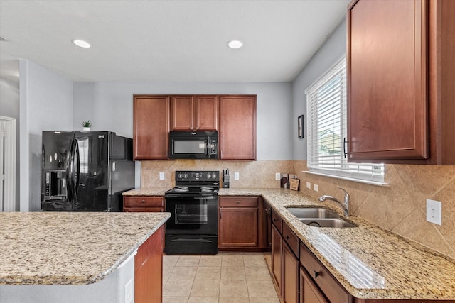 9129 Blackstone Dr, Providence Village, TX 76227 - kitchen with black appliances, a sink, light stone counters, tasteful backsplash, and brown cabinets