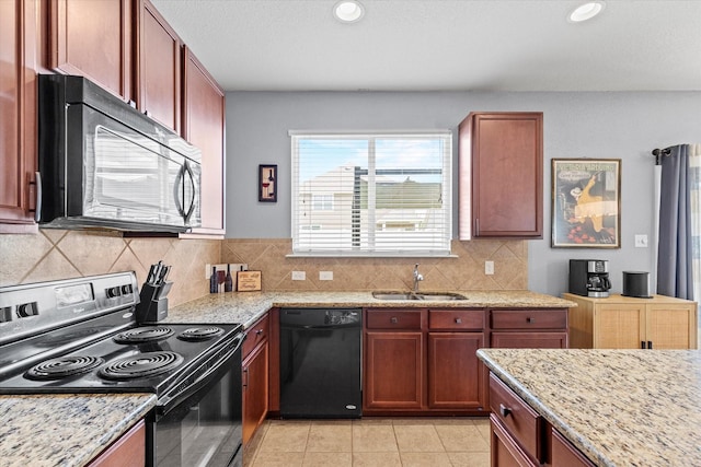 9129 Blackstone Dr, Providence Village, TX 76227 - kitchen featuring black appliances, a sink, backsplash, light stone countertops, and recessed lighting