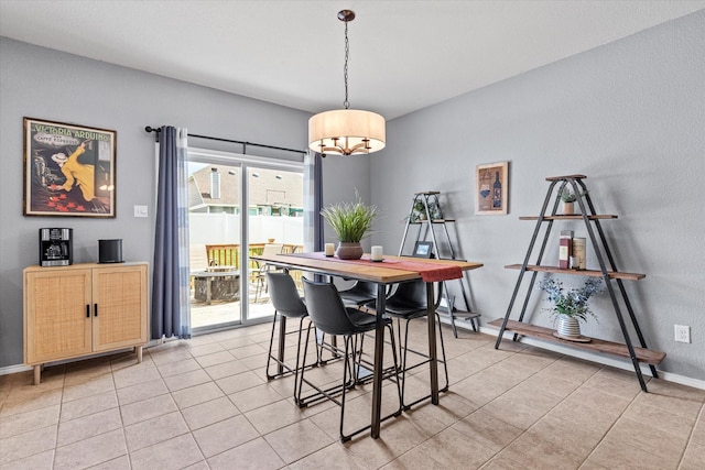 9129 Blackstone Dr, Providence Village, TX 76227 - dining area with a chandelier, light tile patterned floors, and baseboards