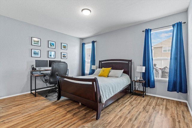 9129 Blackstone Dr, Providence Village, TX 76227 - bedroom with light wood-type flooring, baseboards, and a desk