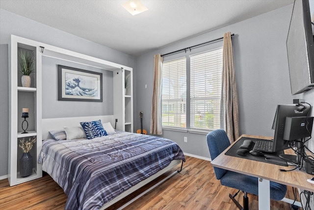 9129 Blackstone Dr, Providence Village, TX 76227 - bedroom featuring wood finished floors, baseboards, and an office area
