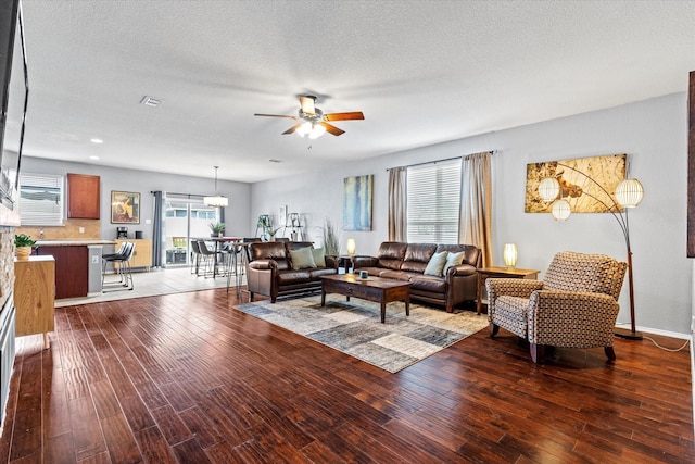 9129 Blackstone Dr, Providence Village, TX 76227 - living area with ceiling fan, wood finished floors, a textured ceiling, and baseboards