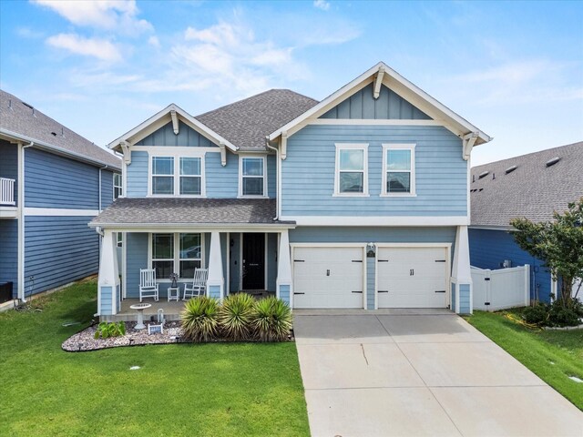 2132 Dewitt Ln, Providence Village, TX 76227 - craftsman-style home with covered porch, board and batten siding, driveway, and an attached garage