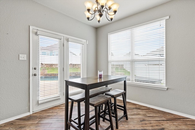 2132 Dewitt Ln, Providence Village, TX 76227 - dining space featuring a chandelier, wood finished floors, baseboards, and a textured wall