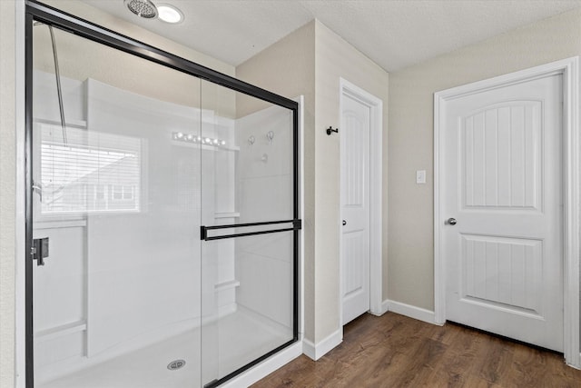 2132 Dewitt Ln, Providence Village, TX 76227 - full bath featuring a stall shower, wood finished floors, baseboards, and a chandelier