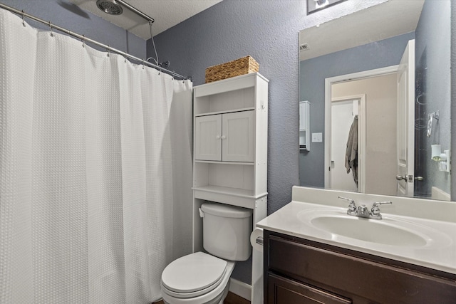 2132 Dewitt Ln, Providence Village, TX 76227 - bathroom with toilet, vanity, a textured wall, and curtained shower