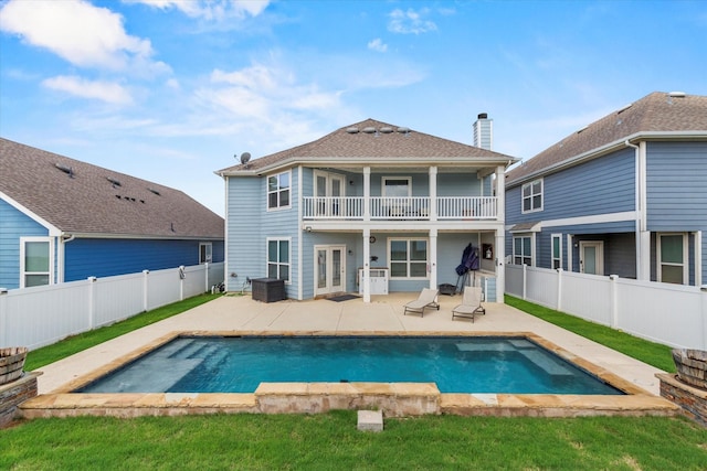 2132 Dewitt Ln, Providence Village, TX 76227 - rear view of property with a balcony, a patio, a fenced backyard, and french doors