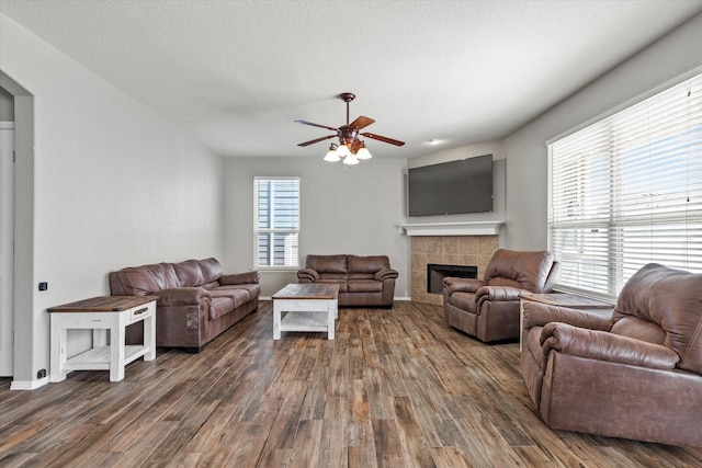 2132 Dewitt Ln, Providence Village, TX 76227 - living area featuring ceiling fan, wood finished floors, a tile fireplace, and baseboards
