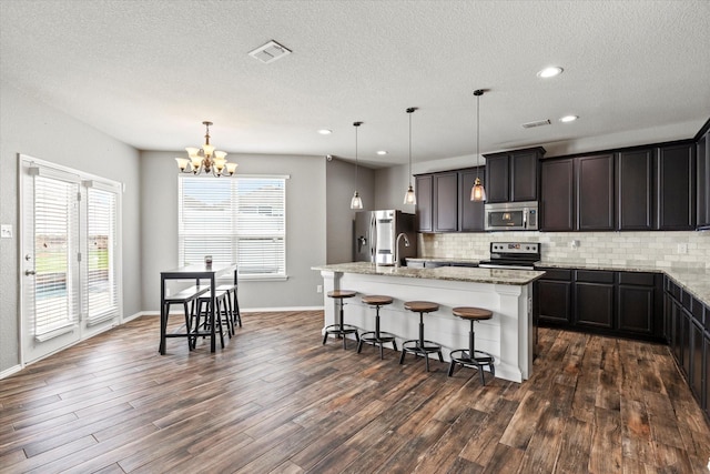 2132 Dewitt Ln, Providence Village, TX 76227 - kitchen with appliances with stainless steel finishes, backsplash, dark wood-type flooring, a textured ceiling, and recessed lighting