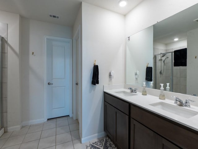 519 Stampede Ln, Princeton, TX 75407 - bathroom featuring a shower stall, baseboards, double vanity, and tile patterned flooring