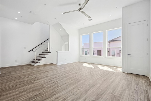 2235 Lovedale Ave Unit 102, Dallas, TX 75235 - unfurnished living room with light wood-style flooring, ceiling fan, stairs, baseboards, and recessed lighting