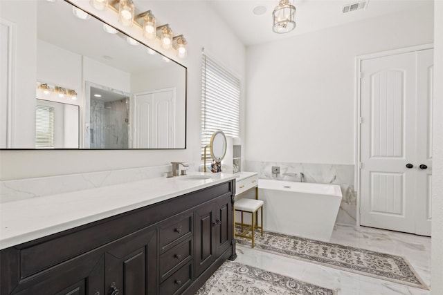 10040 Horseshoe Nail Rd, Pilot Point, TX 76258 - bathroom with marble look tile flooring, a soaking tub, vanity, and a shower stall