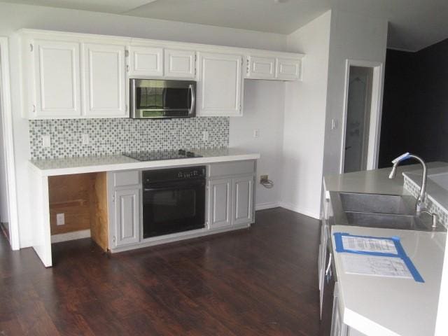 101 Ginger Dr, Pottsboro, TX 75076 - kitchen featuring black appliances, a sink, tasteful backsplash, and dark wood-style flooring