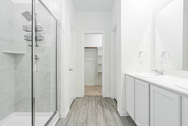 624 Beltrand Ln, Fate, TX 75087 - full bathroom with a shower stall, wood finished floors, and double vanity