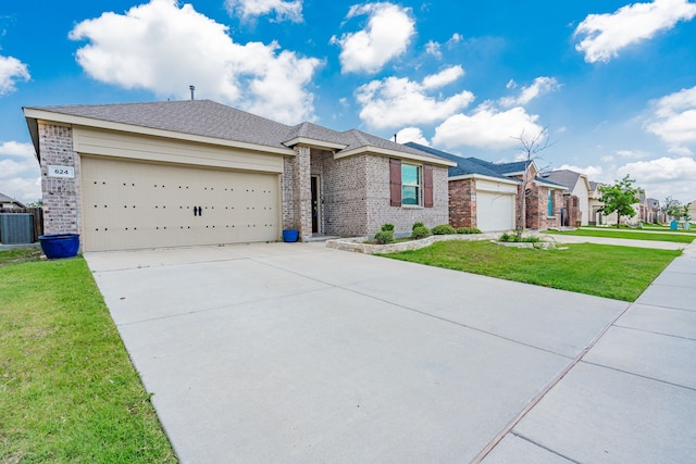624 Beltrand Ln, Fate, TX 75087 - ranch-style home featuring brick siding, driveway, an attached garage, a front yard, and central AC