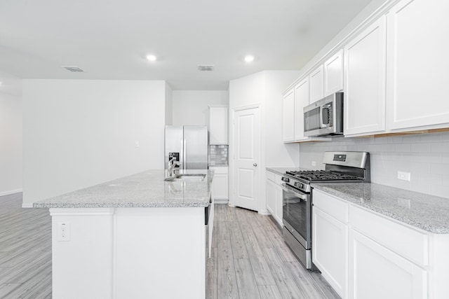 624 Beltrand Ln, Fate, TX 75087 - kitchen featuring appliances with stainless steel finishes, a sink, light wood-style flooring, recessed lighting, and decorative backsplash