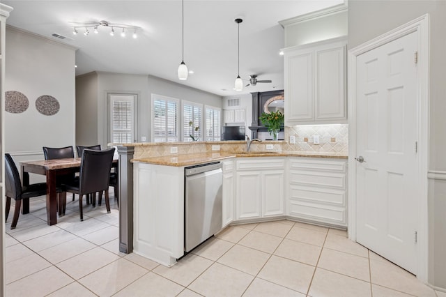 3908 Sagamore Hill Ct, Plano, TX 75025 - kitchen with stainless steel dishwasher, a sink, a peninsula, light tile patterned floors, and crown molding
