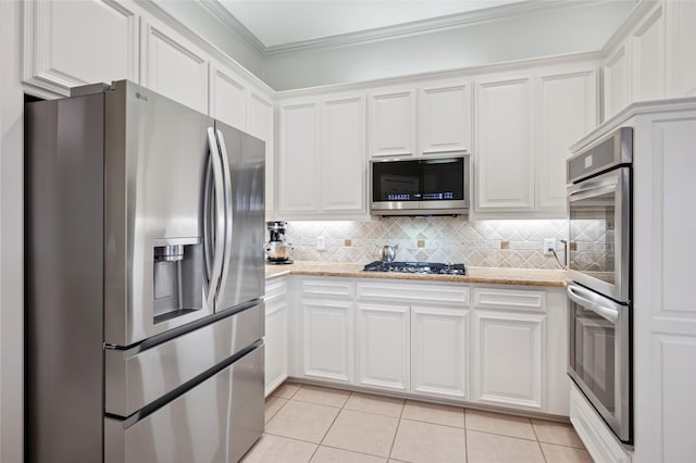 3908 Sagamore Hill Ct, Plano, TX 75025 - kitchen featuring appliances with stainless steel finishes, white cabinets, light tile patterned floors, tasteful backsplash, and ornamental molding