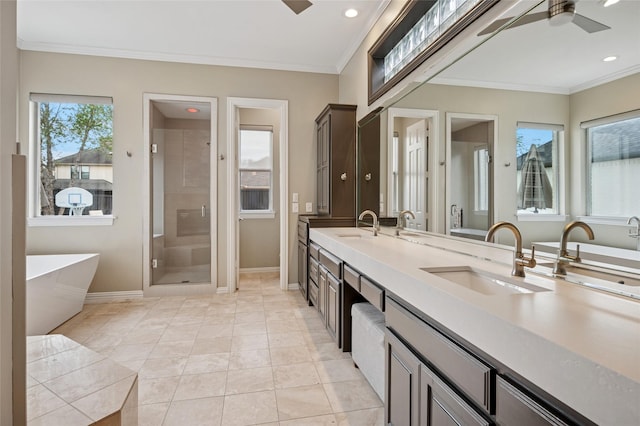 3908 Sagamore Hill Ct, Plano, TX 75025 - bathroom featuring double vanity, a freestanding tub, baseboards, a shower stall, and ornamental molding