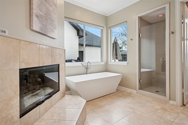 3908 Sagamore Hill Ct, Plano, TX 75025 - full bath featuring a freestanding tub, a shower stall, ornamental molding, a tiled fireplace, and baseboards