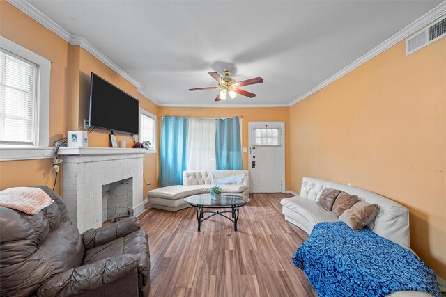 1815 Proctor Ave, Waco, TX 76708 - living room featuring healthy amount of natural light, crown molding, ceiling fan, wood finished floors, and baseboards