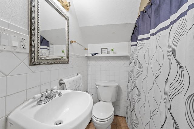 1815 Proctor Ave, Waco, TX 76708 - full bath featuring tile walls, a sink, toilet, tile patterned floors, and a shower with shower curtain