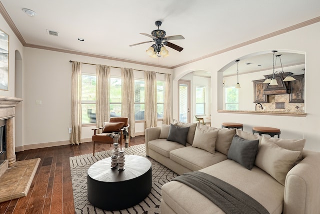11048 Fernbury Dr, Fort Worth, TX 76179 - living room with ceiling fan, dark wood finished floors, arched walkways, a premium fireplace, and healthy amount of natural light