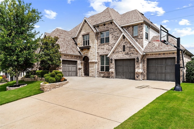 3480 Newport Dr, Prosper, TX 75078 - french country style house featuring a front yard, roof with shingles, driveway, and brick siding