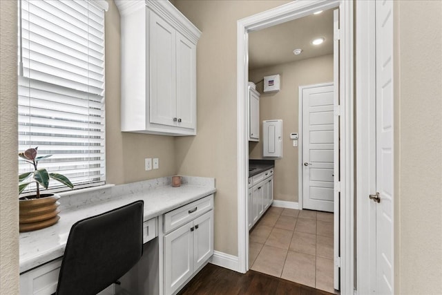 3480 Newport Dr, Prosper, TX 75078 - home office with baseboards, built in study area, and dark wood-type flooring