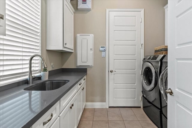 3480 Newport Dr, Prosper, TX 75078 - laundry area featuring cabinet space, washer and clothes dryer, light tile patterned floors, baseboards, and electric panel