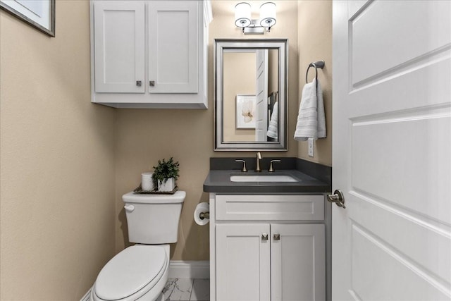 3480 Newport Dr, Prosper, TX 75078 - half bath with vanity, toilet, marble finish floors, and baseboards