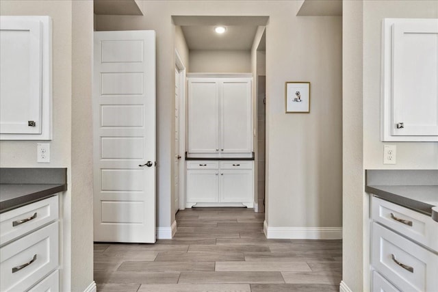 3480 Newport Dr, Prosper, TX 75078 - kitchen featuring baseboards, dark countertops, white cabinetry, and light wood-style floors