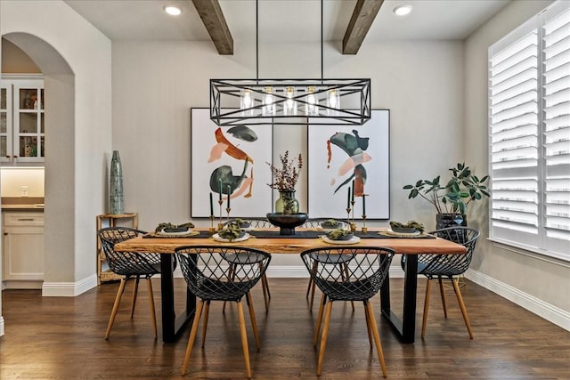 3480 Newport Dr, Prosper, TX 75078 - dining space with arched walkways, beamed ceiling, dark wood finished floors, healthy amount of natural light, and baseboards