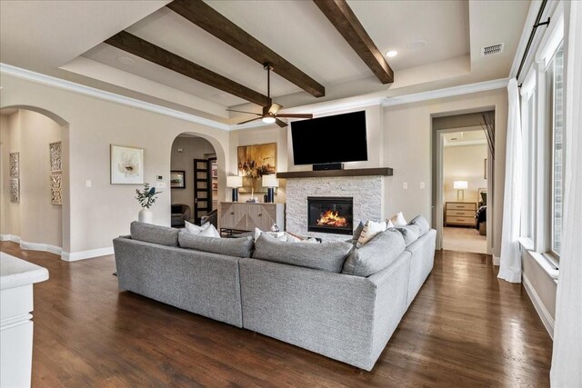 3480 Newport Dr, Prosper, TX 75078 - living area featuring a ceiling fan, arched walkways, a fireplace, beam ceiling, and baseboards