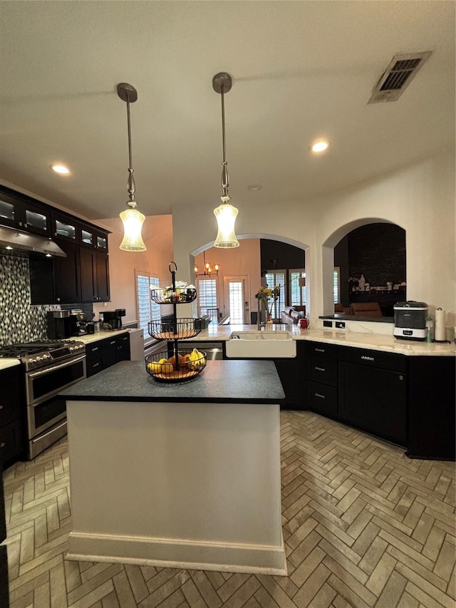 1549 Alamo Bell Way, Fort Worth, TX 76052 - kitchen with range with two ovens, decorative backsplash, recessed lighting, under cabinet range hood, and dark cabinetry