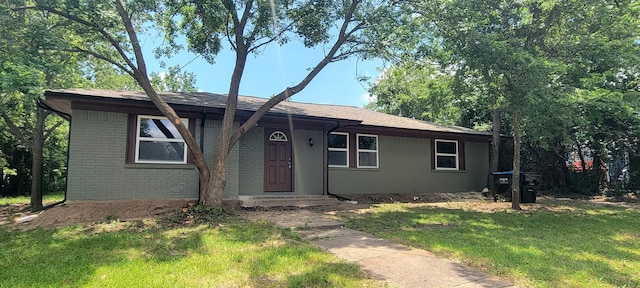 4017 Pickett St, Greenville, TX 75401 - ranch-style home with a front yard and brick siding