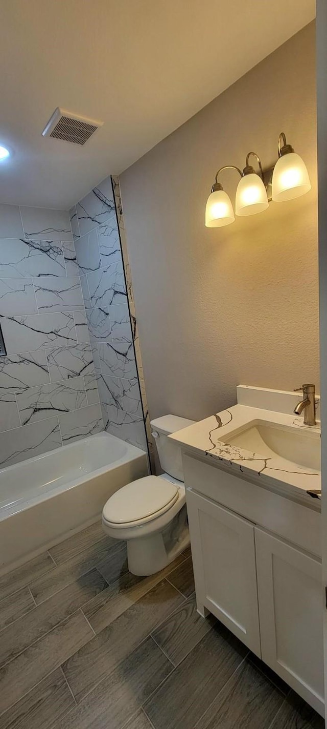 4017 Pickett St, Greenville, TX 75401 - full bath with vanity, shower / washtub combination, toilet, and wood tiled floors