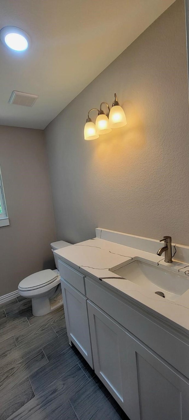 4017 Pickett St, Greenville, TX 75401 - half bath with toilet, vanity, and wood tiled floors