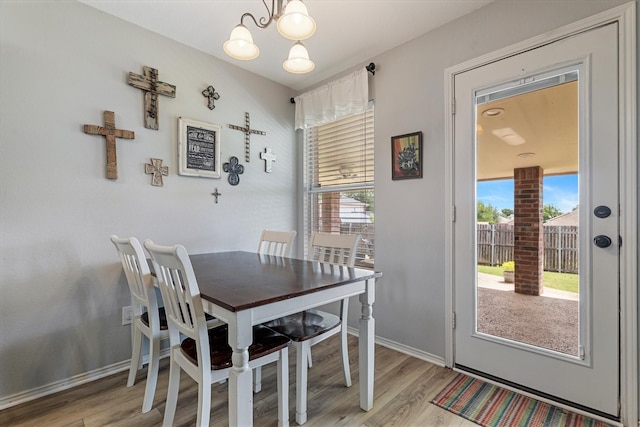 1036 Ridgetop Dr, Justin, TX 76247 - dining area with a chandelier, light wood-style floors, and baseboards